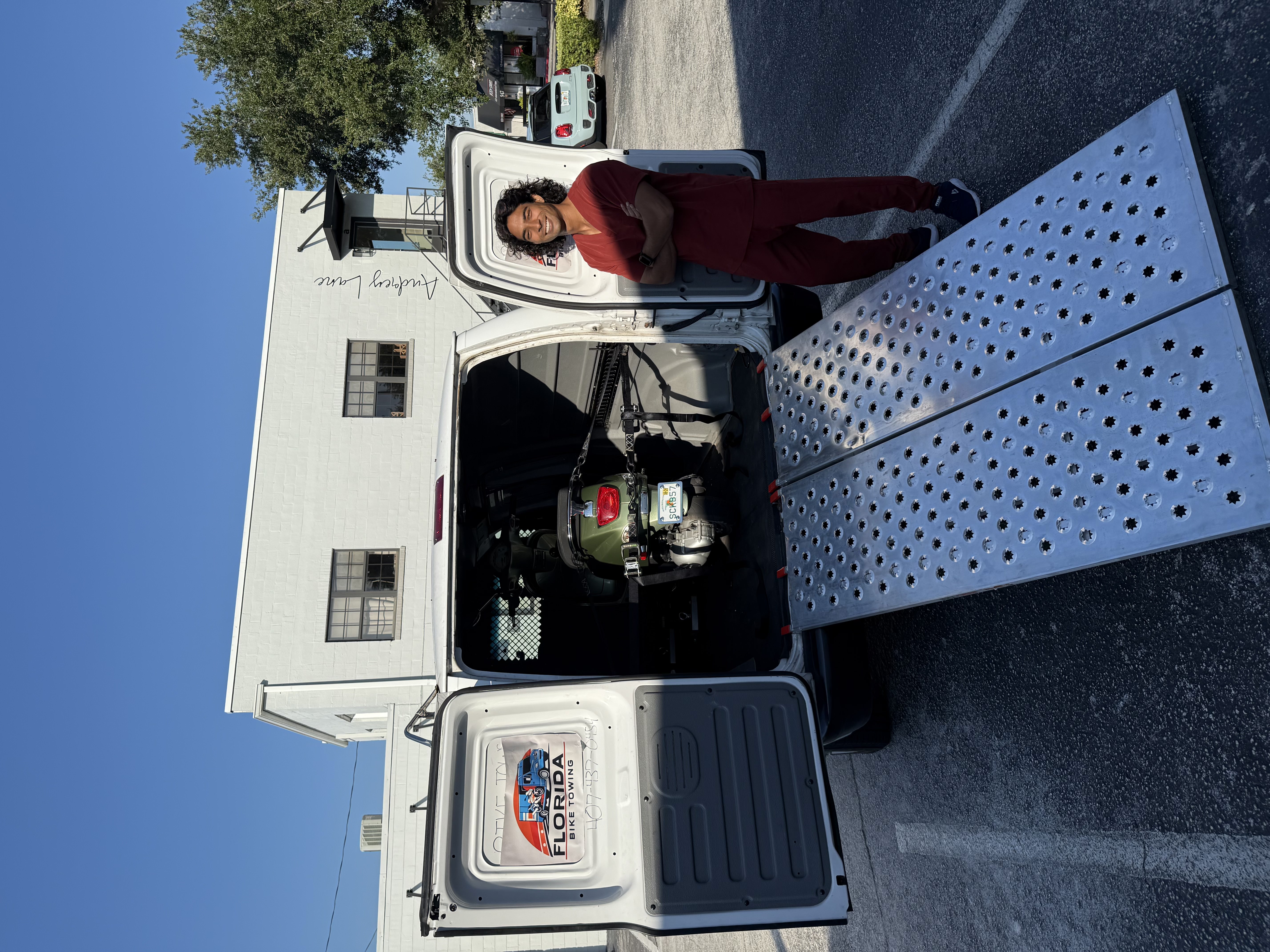 Scooter being towed safely on a motorcycle carrier in Kissimmee