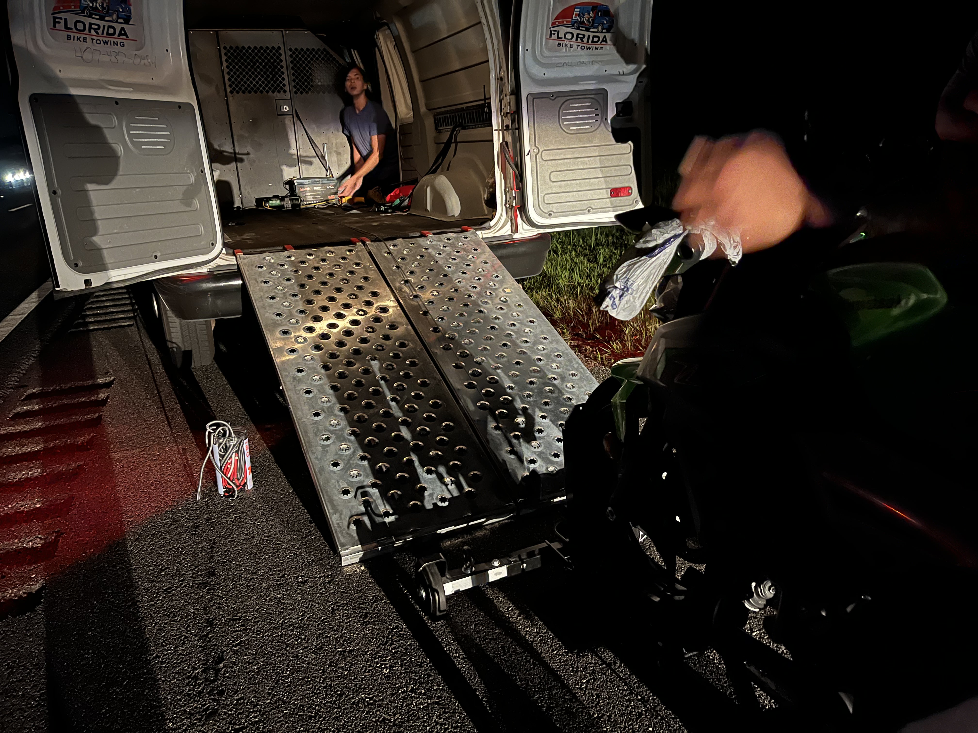 Sportbike being carefully strapped and loaded for motorcycle towing in Orlando